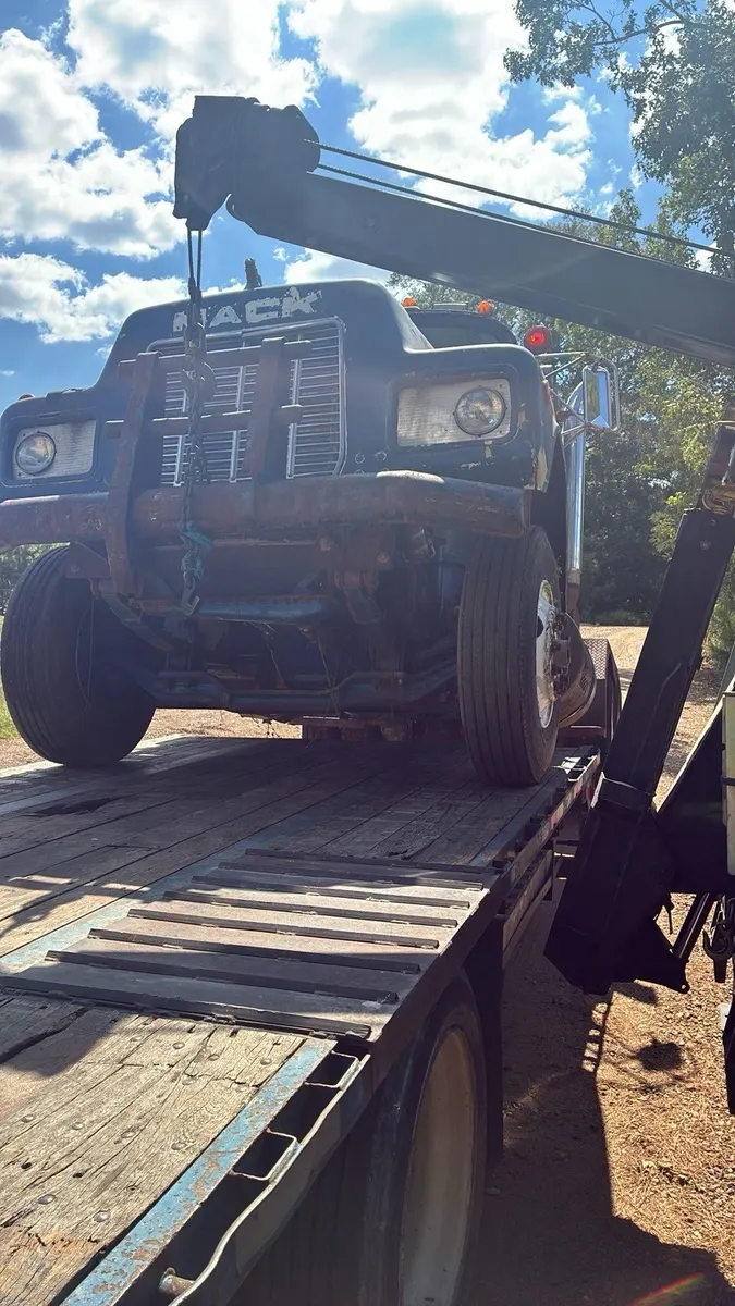 Mack truck being loaded onto a trailer
