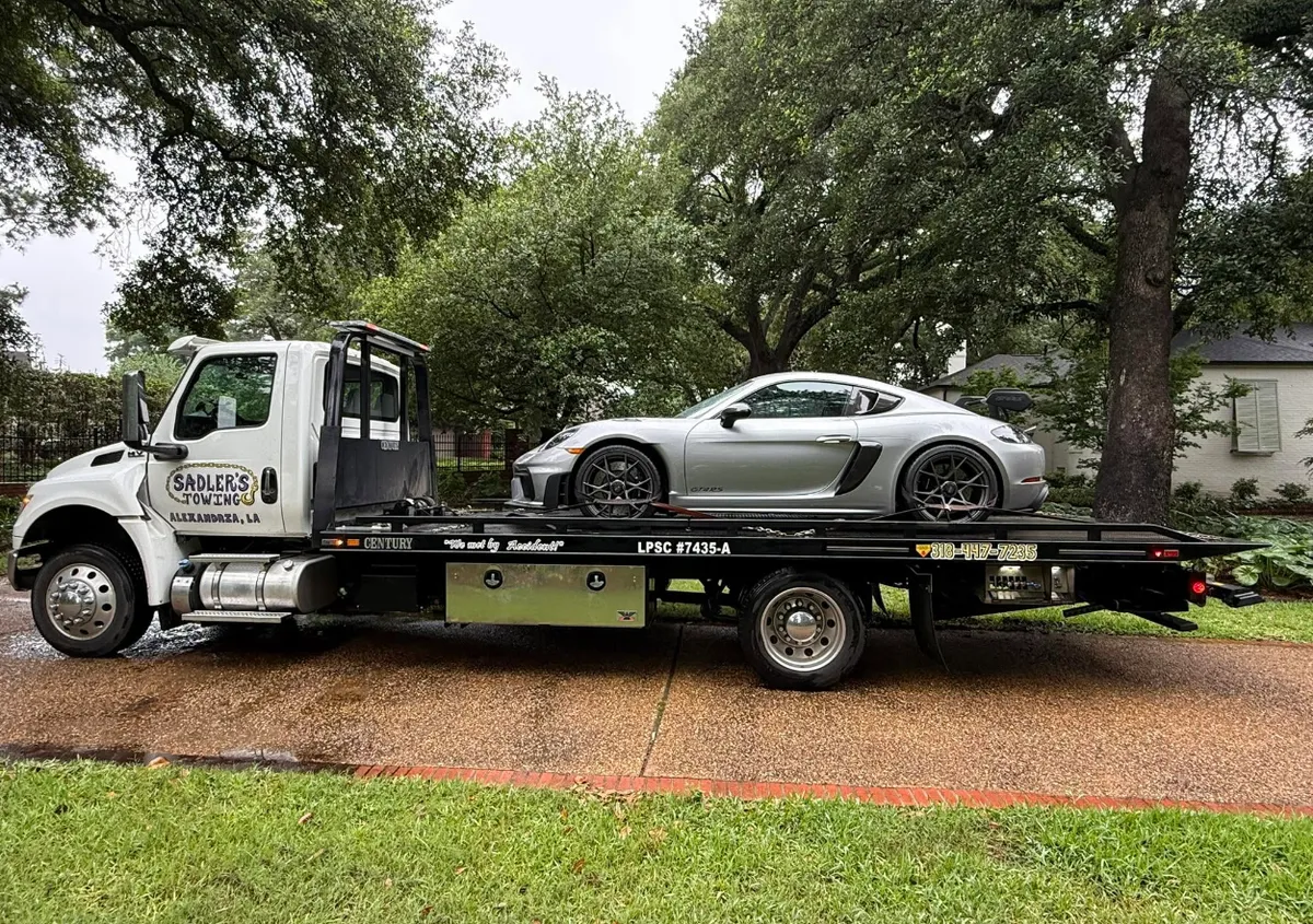 Sadler's Towing rollback carrying a silver Porsche